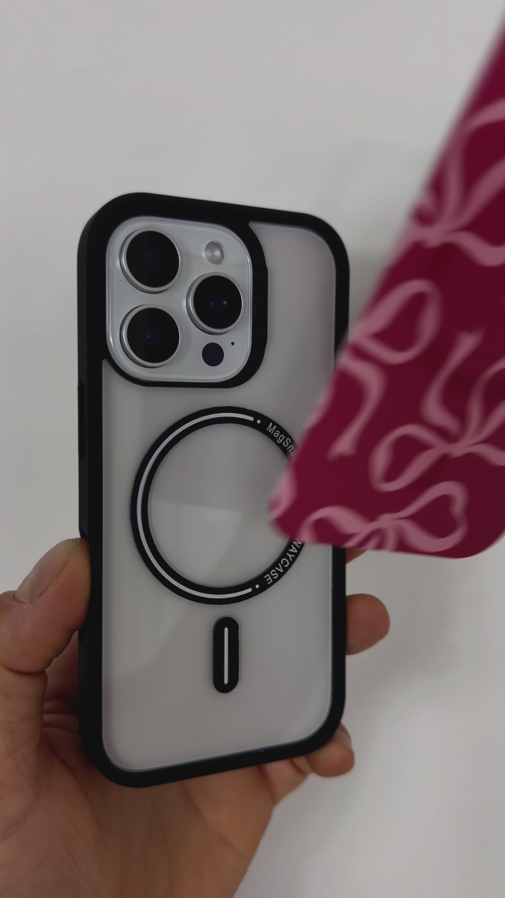 Video showcasing the Tough MagSafe® iPhone Case with MagSnap™ Pink Bows design, featuring delicate pink bow patterns on a magnetic back cover. Demonstrates easy snap-on interchangeability, stylish personalisation, and secure MagSafe® compatibility.