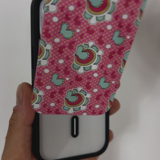 Video demonstrating the Tough MagSafe® iPhone Case with MagSnap™ Hearts design, highlighting the effortless interchangeability of magnetic back covers. The user showcases how the heart-patterned cover securely snaps on and off, emphasising customisable aesthetics and seamless MagSafe compatibility.