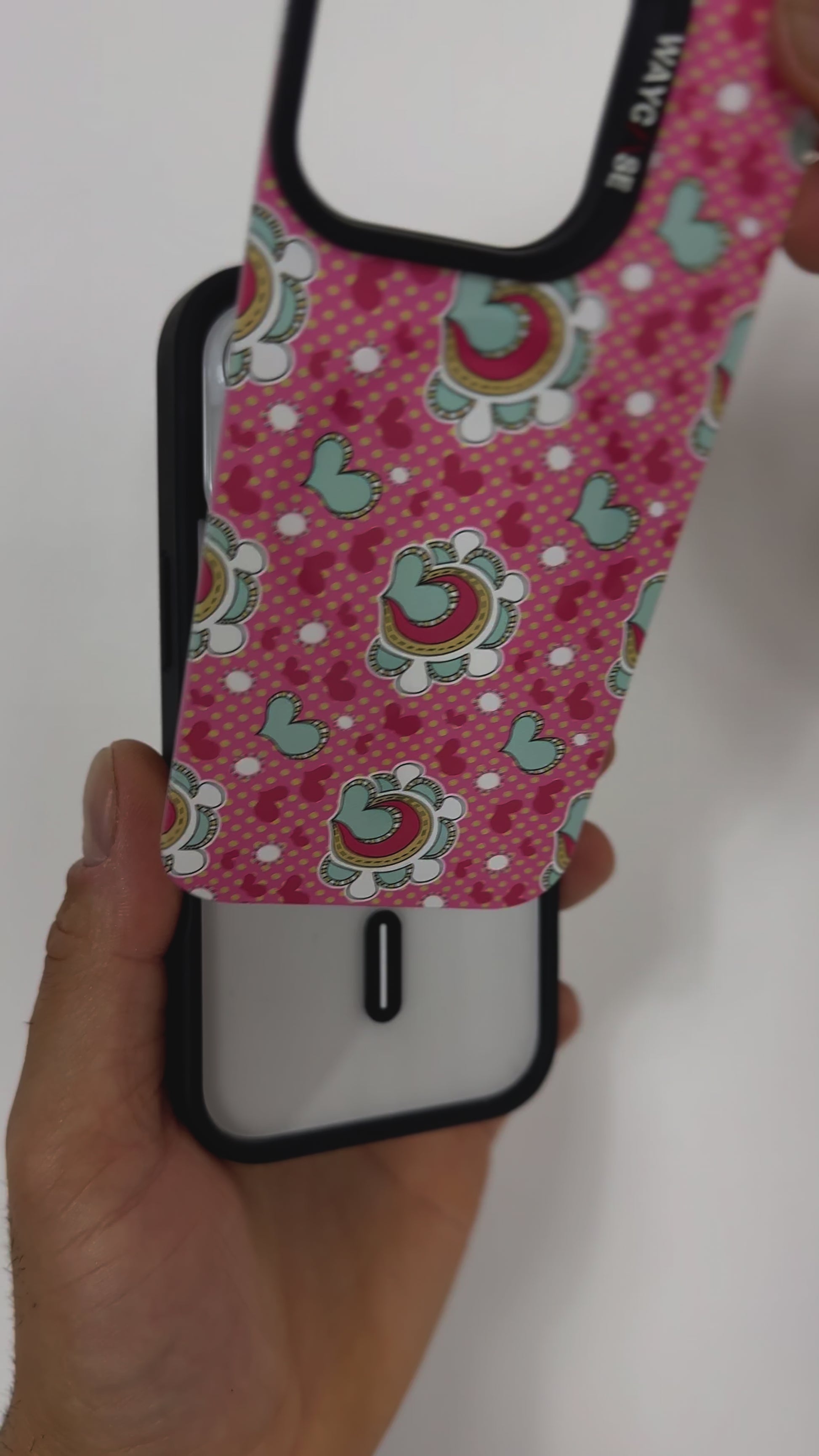 Video demonstrating the Tough MagSafe® iPhone Case with MagSnap™ Hearts design, highlighting the effortless interchangeability of magnetic back covers. The user showcases how the heart-patterned cover securely snaps on and off, emphasising customisable aesthetics and seamless MagSafe compatibility.