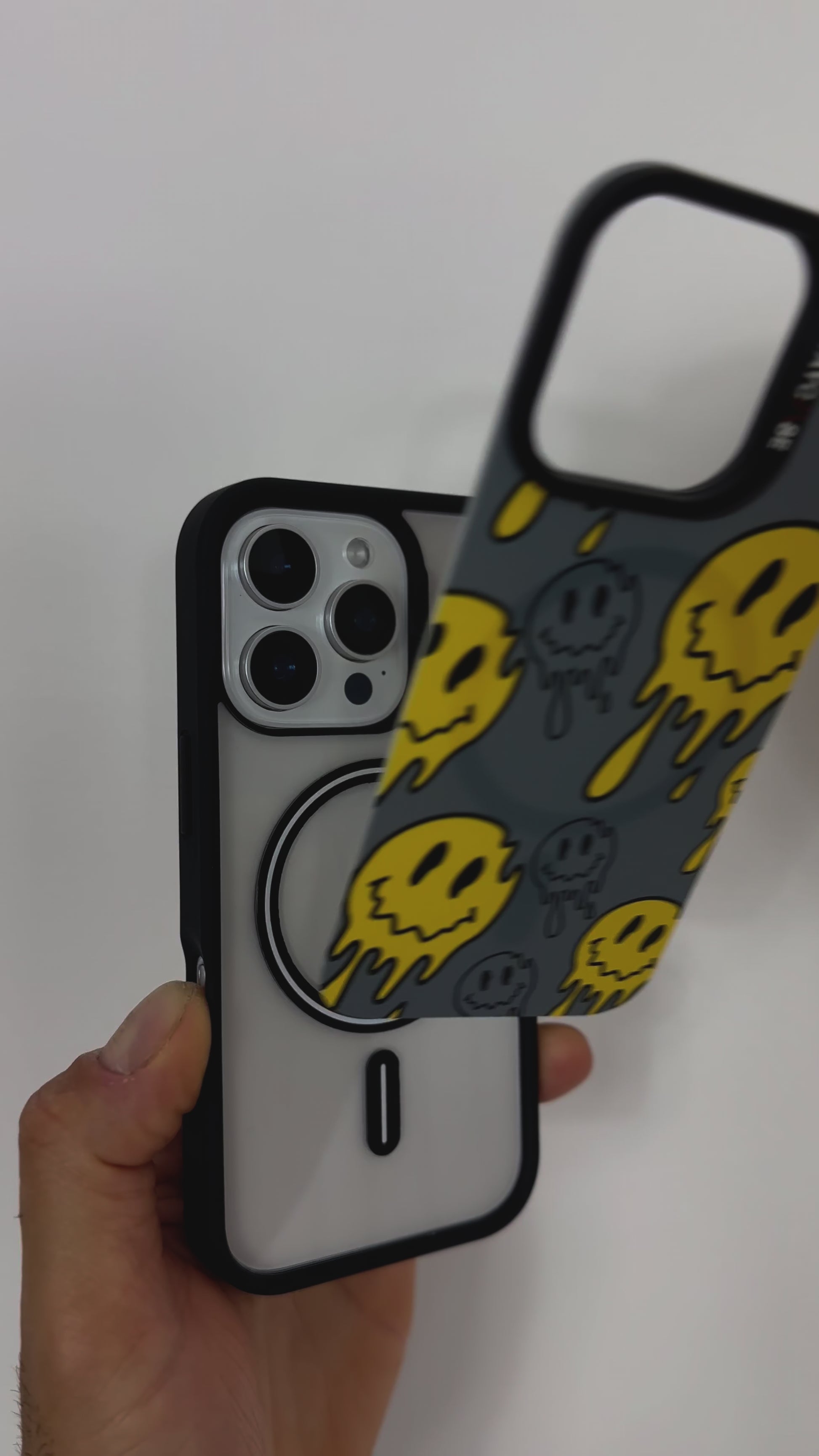 Video featuring the Tough MagSafe® iPhone Case with MagSnap™ Melted Emoji design. Highlights the bold, drippy emoji artwork on a magnetic back cover that snaps on and off easily. Demonstrates strong MagSafe® compatibility and playful, swappable customisation.