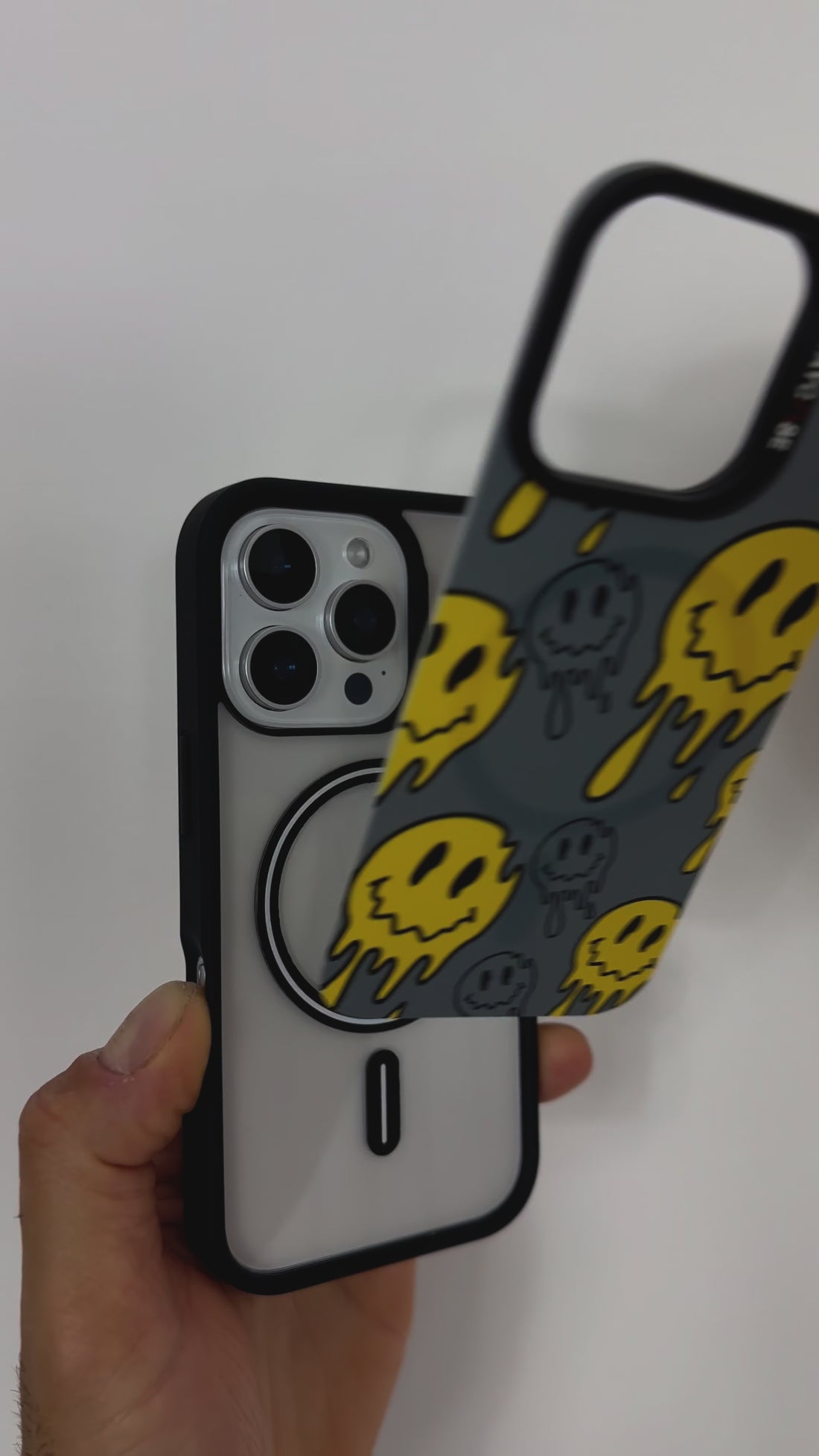Video featuring the Tough MagSafe® iPhone Case with MagSnap™ Melted Emoji design. Highlights the bold, drippy emoji artwork on a magnetic back cover that snaps on and off easily. Demonstrates strong MagSafe® compatibility and playful, swappable customisation.